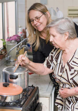 woman stirring pot with assistance