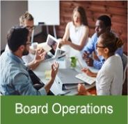 Click on this image of board members at a table with a lap top for information on Board Operations.