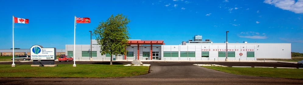 Picture of the Food Development Centre's entrance in Portage la Praririe on a sunny day in summer.