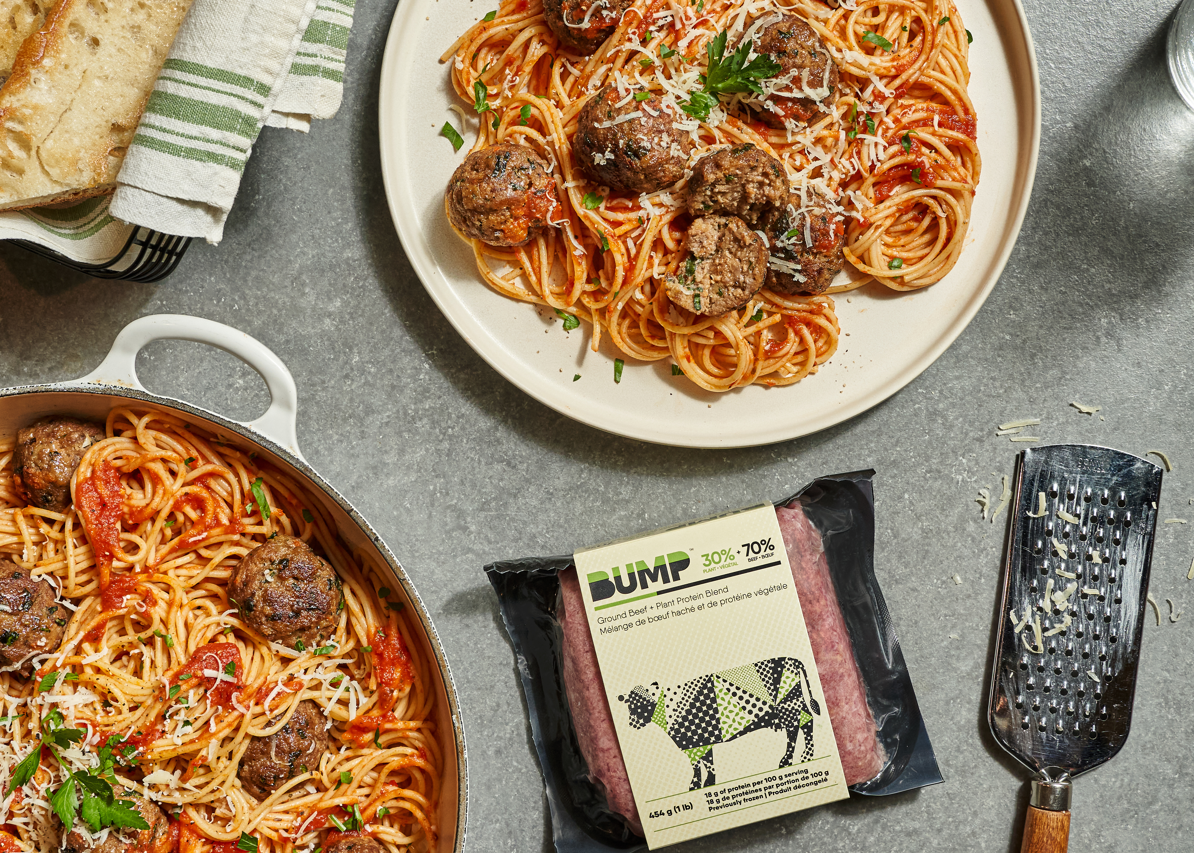 Photo of spaghetti and meatballs on a serving dish next to a package of Bump blended ground beef with plant-based proteins
