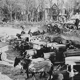 photo of the construction of the Civic Auditorium building in 1932, with construction works excavating with ground, pick-up trucks filled with dirt, and work horses