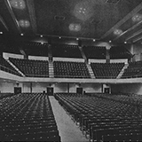 Photo of the interior of the main auditorium in 1933. There are three levels with many rows of empty seats.