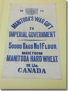 flour sack labelled '1914, Manitoba's War Gift to Imperial Government, 50,000 Bags No 1 Flour, made from Manitoba Hard Wheat, 98 lbs, Canada'