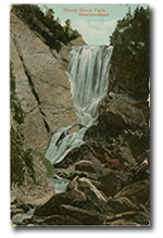 front of postcard “Steady Brook Falls, Newfoundland” with illustration of waterfall