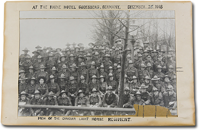 Photo of a group of soldiers in uniform “At The Rhine Hotel Godesberg, Germany, December 25, 1918. Men of the Canadian Light Horse Regiment.”