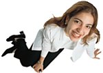 teenager sitting on ground, looking up and smiling