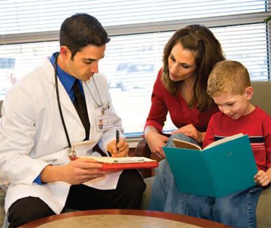 doctor showing notes to woman and boy