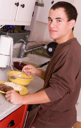 man in a kitchen with a plate of food