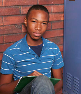 boy sitting with a book on his lap