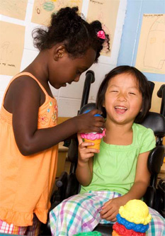 two children smiling and playing with pretend ice cream