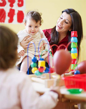 woman holding a child smiling