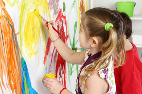 girl painting on a wall