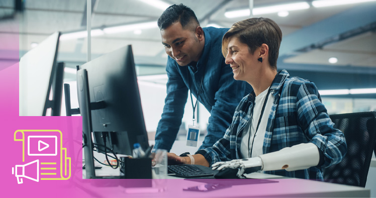 Teamwork in a diverse office, two people in front of the computer work station