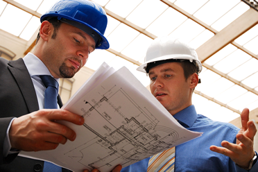 Engineers reviewing building plans