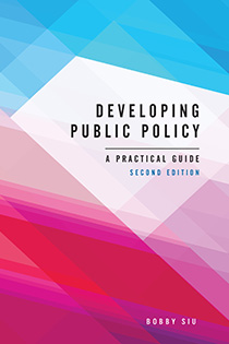 Book cover for Developing Public Policy showing the title over a pink, white, and blue abstract background