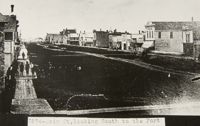 Main Street looking south from Graham Avenue showing the wide mud road and boardwalks.