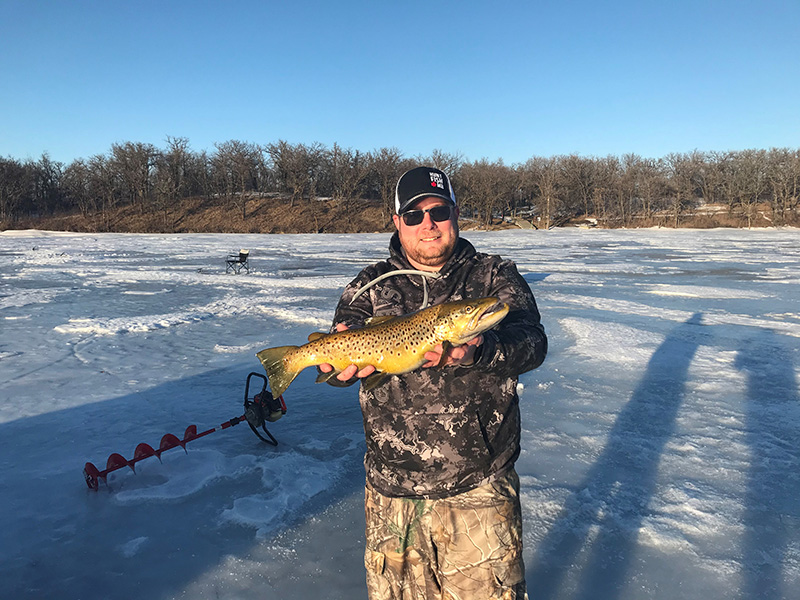 ice fisherman holding fish